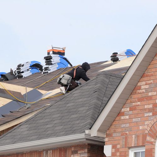 Roofers carrying out roof repairs